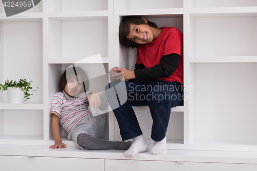 Image of young boys posing on a shelf