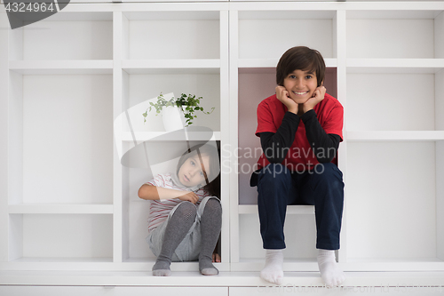 Image of young boys posing on a shelf