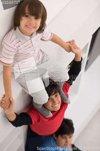 Image of young boys posing line up piggyback top view