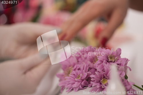 Image of Woman hands receiving a manicure