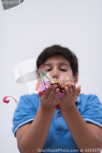 Image of kid blowing confetti