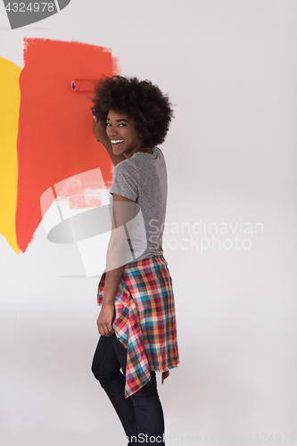 Image of black woman painting wall