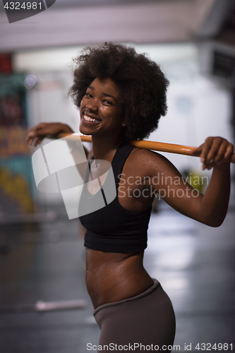 Image of black woman lifting empty bar