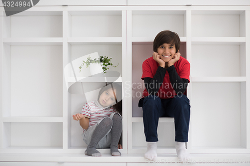 Image of young boys posing on a shelf