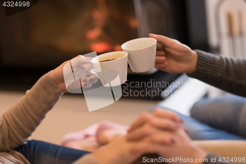 Image of Young couple  in front of fireplace