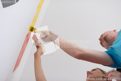 Image of couple painting interior wall