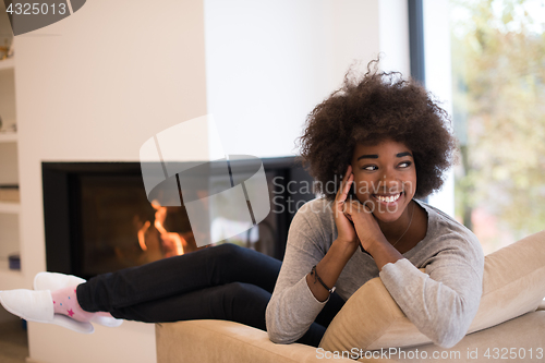 Image of black woman in front of fireplace