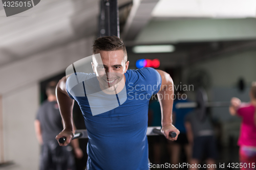 Image of man doing exercises parallel bars