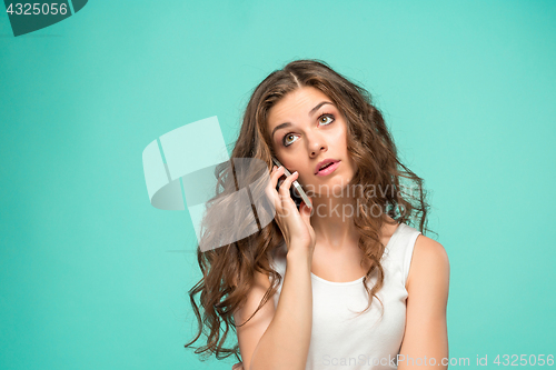 Image of The portrait of disgusted woman with mobile phone