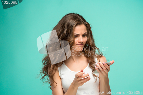 Image of The portrait of disgusted woman with mobile phone