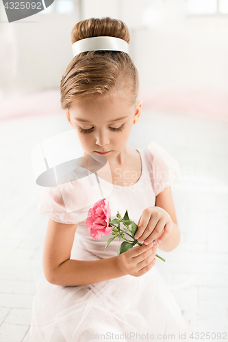 Image of The little balerina in white tutu in class at the ballet school