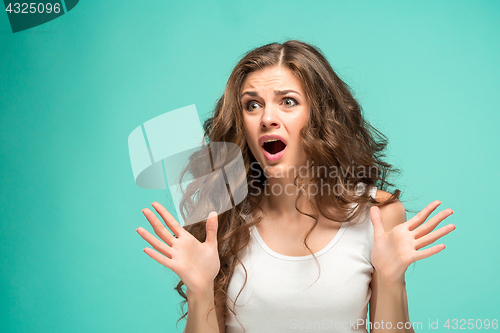 Image of Portrait of young woman with shocked facial expression