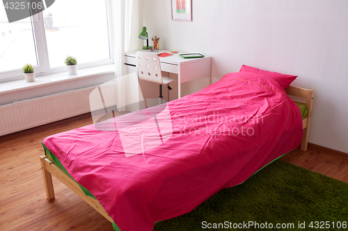 Image of kids room interior with bed, table and accessories