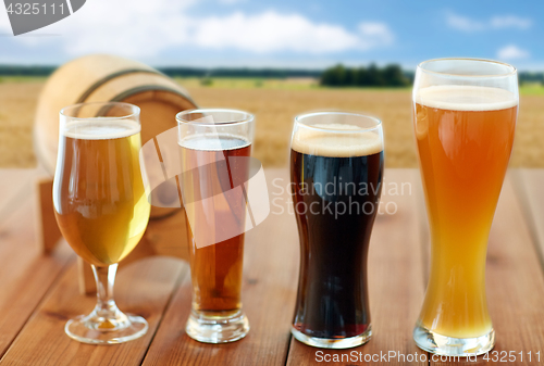 Image of different types of beer in glasses on table