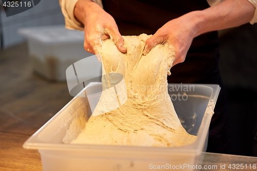 Image of chef or baker cooking dough at bakery