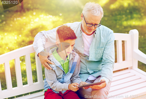 Image of grandfather and boy with tablet pc at summer park