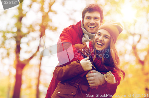 Image of happy young couple hugging in autumn park