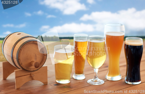 Image of different types of beer in glasses on table