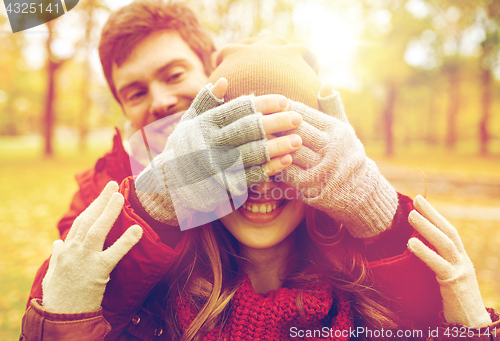 Image of happy young couple having fun in autumn park