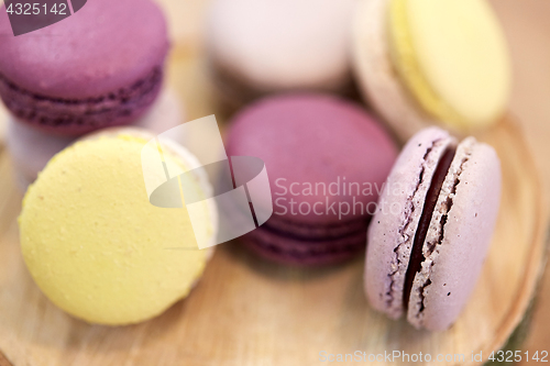 Image of close up of different macarons on wooden stand