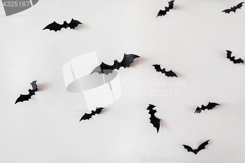 Image of black paper bats over white background