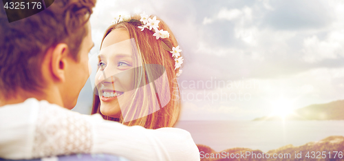 Image of happy smiling young hippie couple over sea