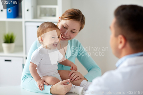 Image of happy woman with baby and doctor at clinic