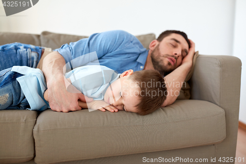 Image of happy father and son sleeping on sofa at home