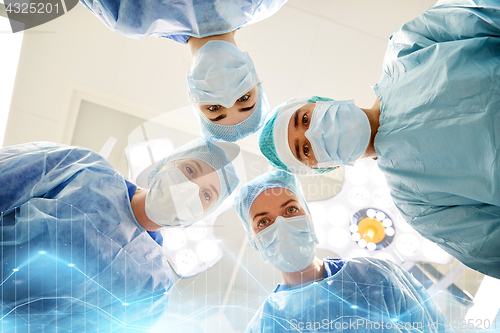 Image of group of surgeons in operating room at hospital