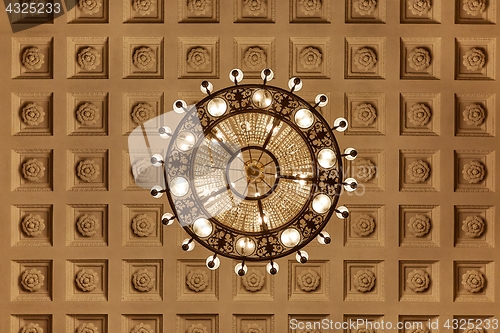 Image of Chandelier on decoarted ceiling