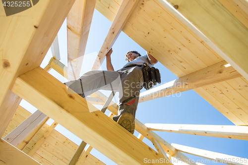 Image of Builders at work with wooden roof construction.