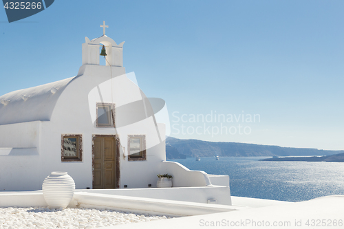 Image of Traditional white orthodox church in Oia, Santorini, Greece.