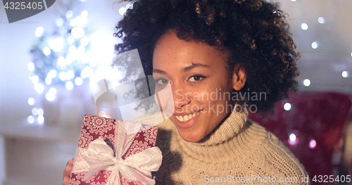 Image of Woman holding Christmas gift with copy space