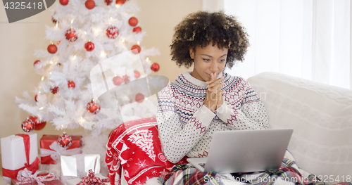 Image of Happy excited woman reading a Christmas message