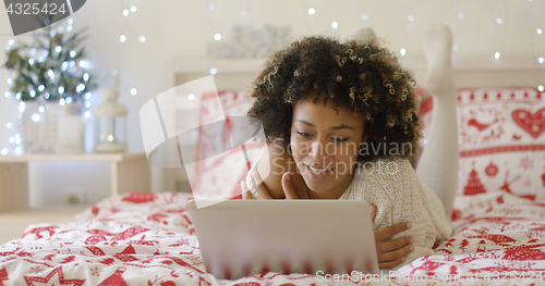 Image of Beautiful Afro American girl lying on bed