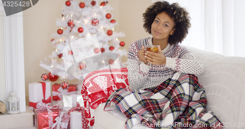 Image of Young woman relaxing at home over Christmas
