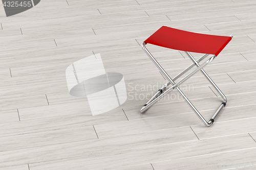 Image of Folding stool on wooden floor