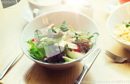 Image of close up of caesar salad on plate at restaurant