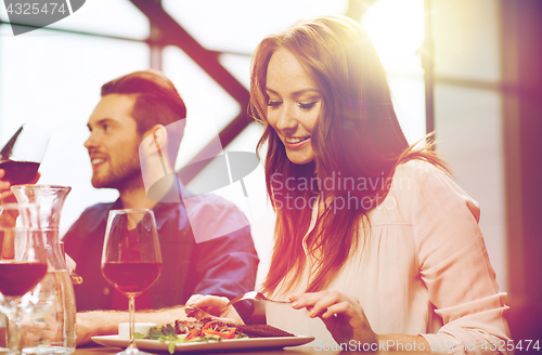 Image of happy couple having dinner at restaurant