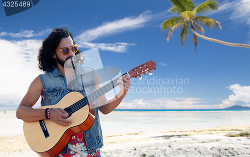 Image of hippie man playing guitar over summer beach