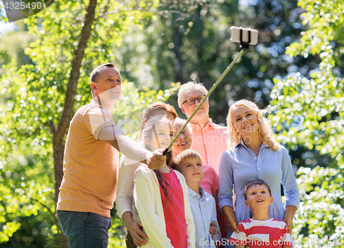 Image of happy family taking selfie in summer garden
