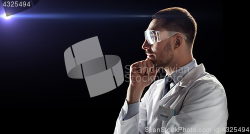 Image of doctor or scientist in lab coat and safety glasses