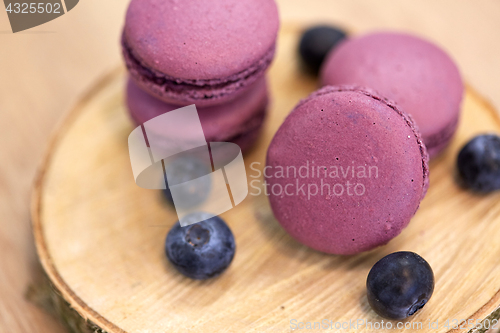 Image of blueberry macarons on wooden stand