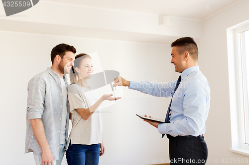 Image of realtor giving keys from new home to happy couple