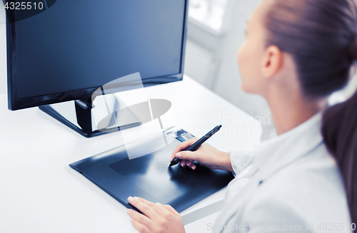 Image of businesswoman with drawing tablet in office