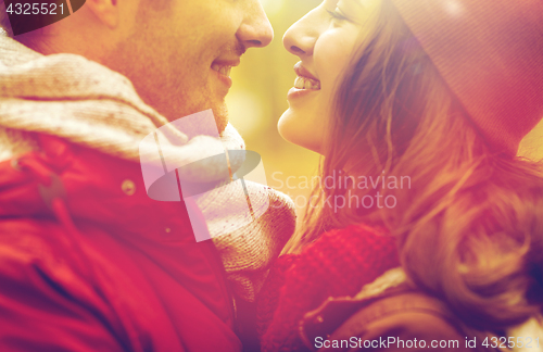 Image of close up of happy young couple kissing outdoors