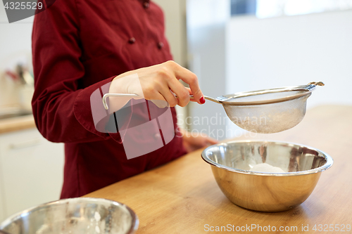 Image of chef with flour in bowl making batter or dough