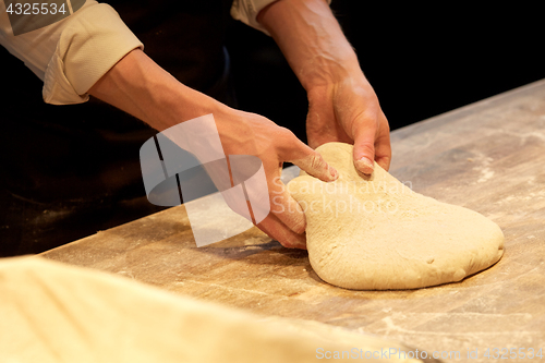 Image of chef or baker cooking dough at bakery