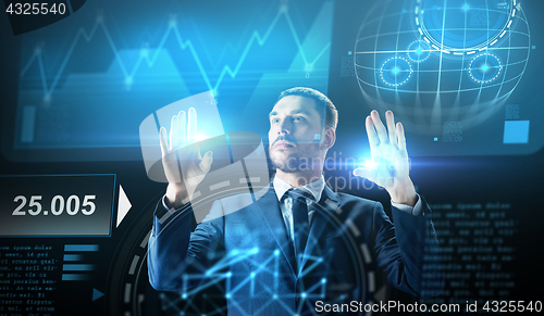 Image of businessman working with charts on virtual screen
