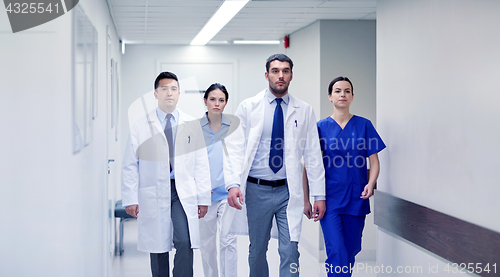 Image of group of medics walking along hospital